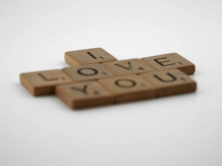 three scrabbled tiles arranged in the same shape