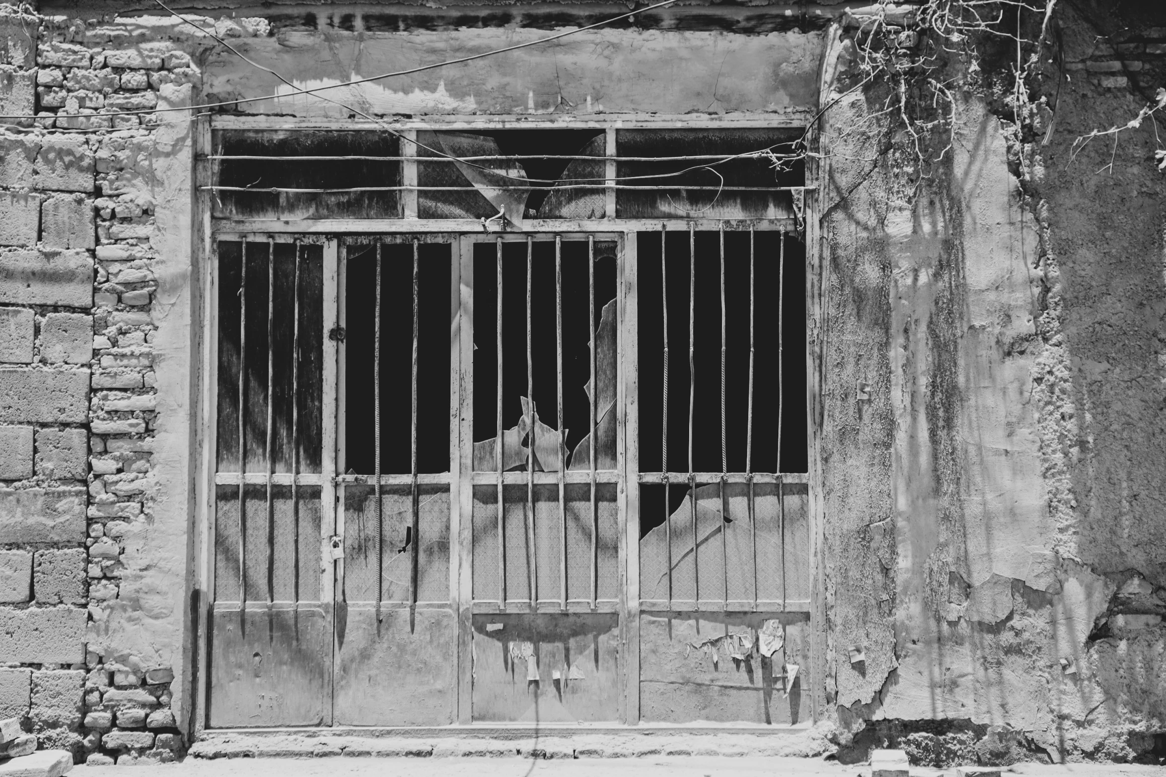 the fence is between two old buildings