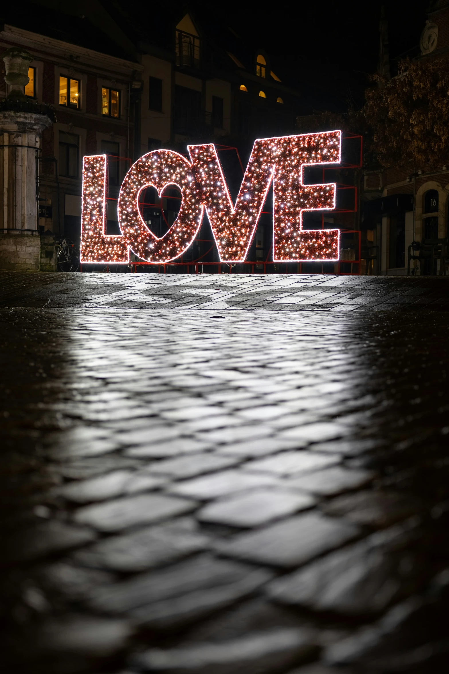 an illuminated sign of the word love in the city