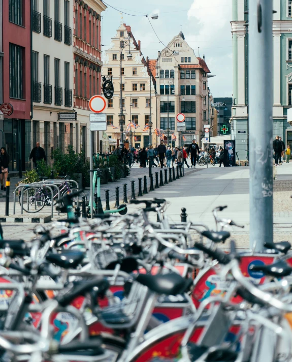 many bikes parked next to each other near the street