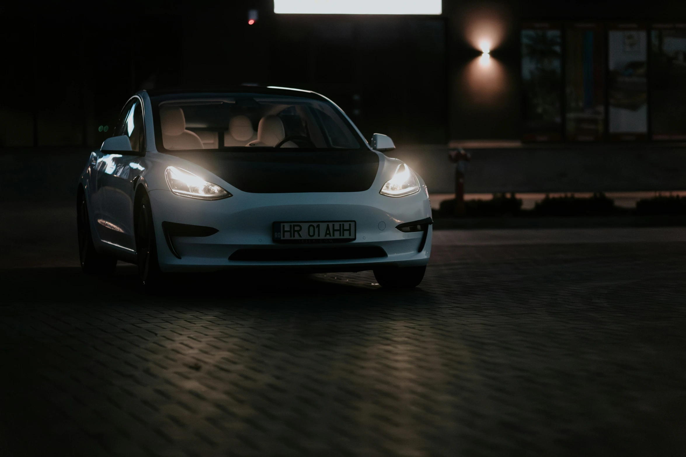 a white car parked in the middle of a road