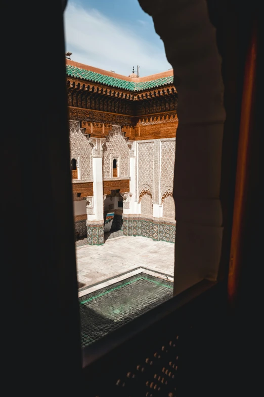 looking out at an open, courtyard from the inner walls of the house