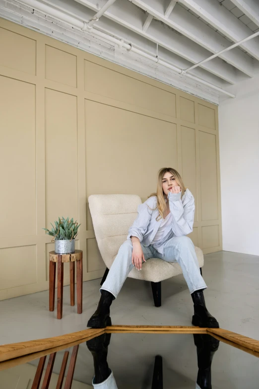 a young woman is sitting on a chair and posing for a po