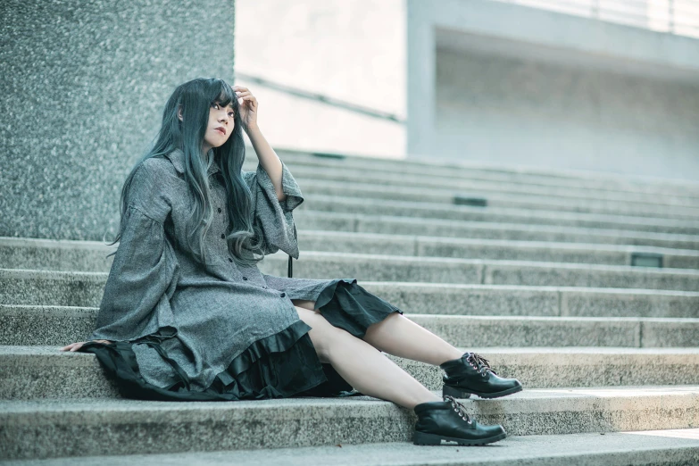 a woman sitting on steps with a umbrella