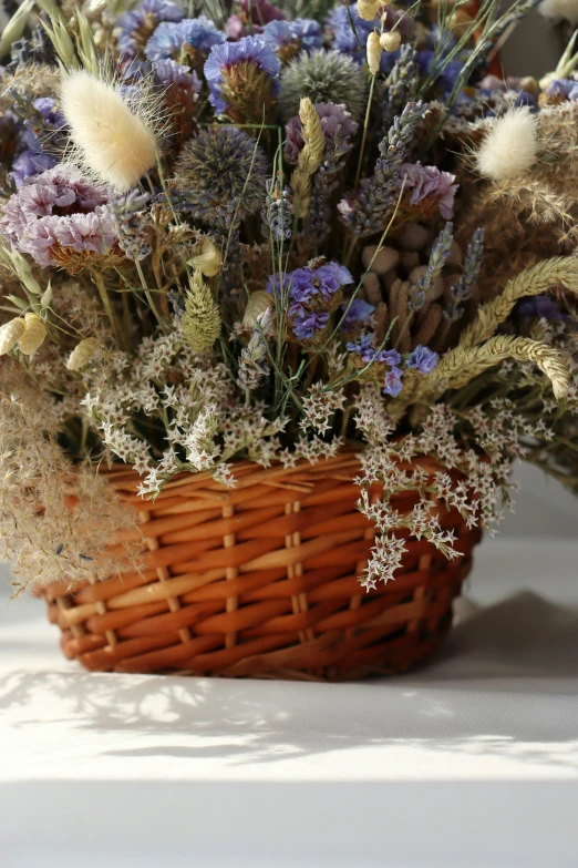 a wicker basket containing different colorful flowers