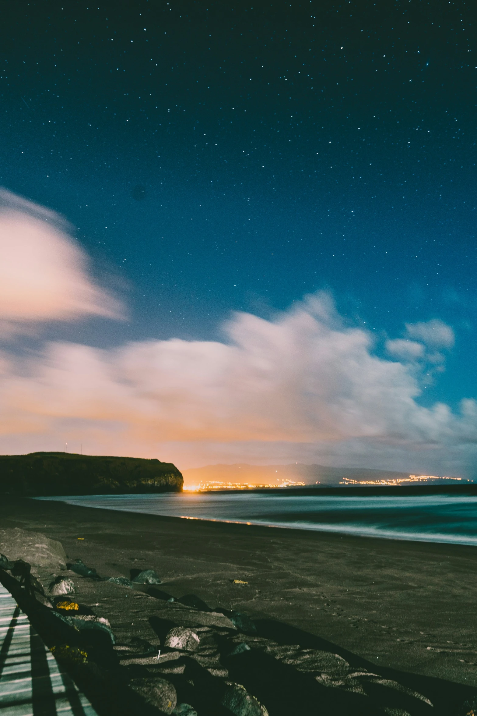 some benches on the sand and the ocean