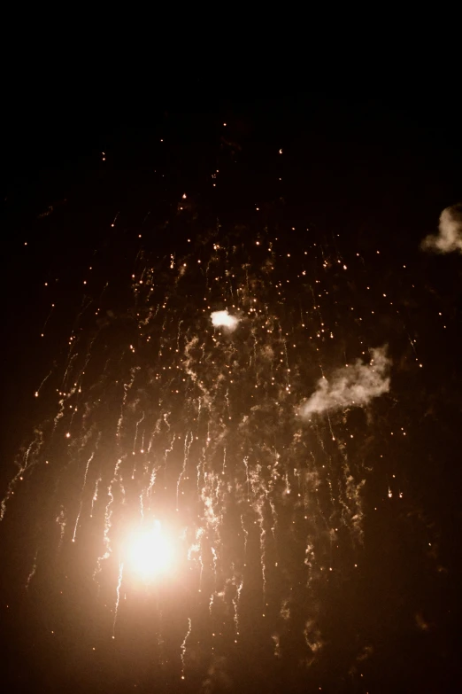 fireworks go out of the sky above the light pole