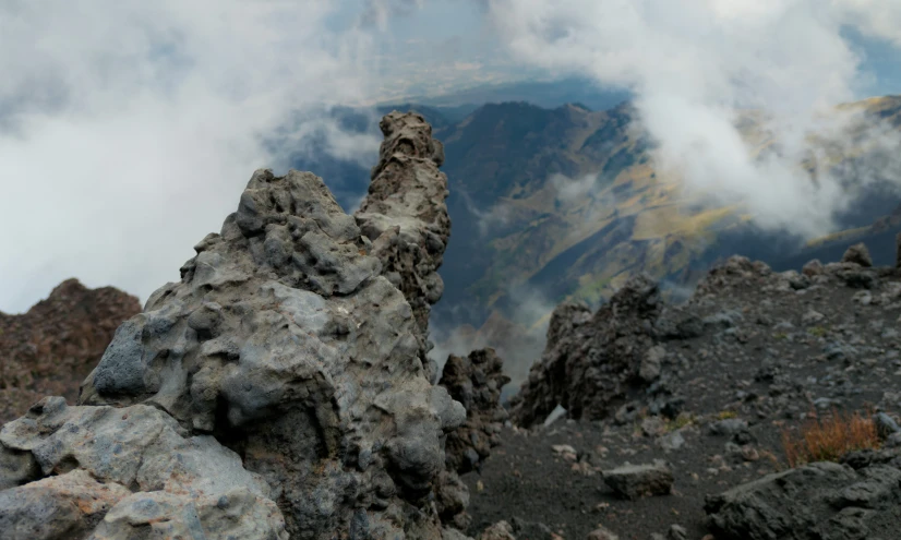 a rock formation with several smaller rocks behind it