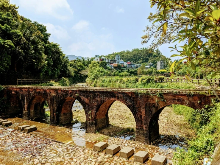 an old brick road bridge spanning a river