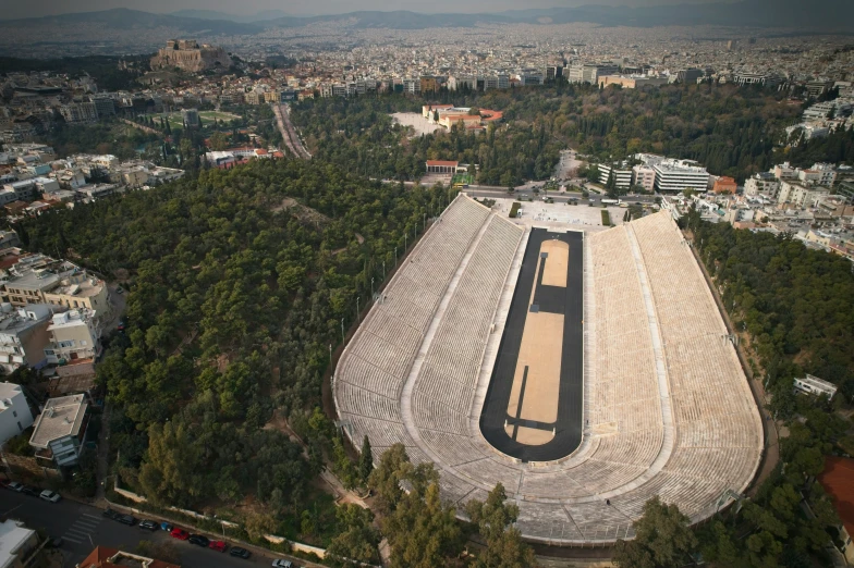 an aerial view of a city with a plane ramp