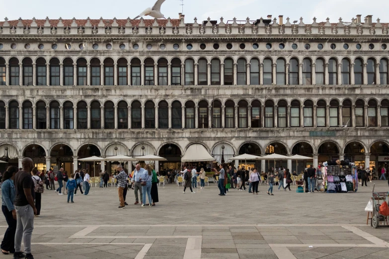 a large brick building with people walking around