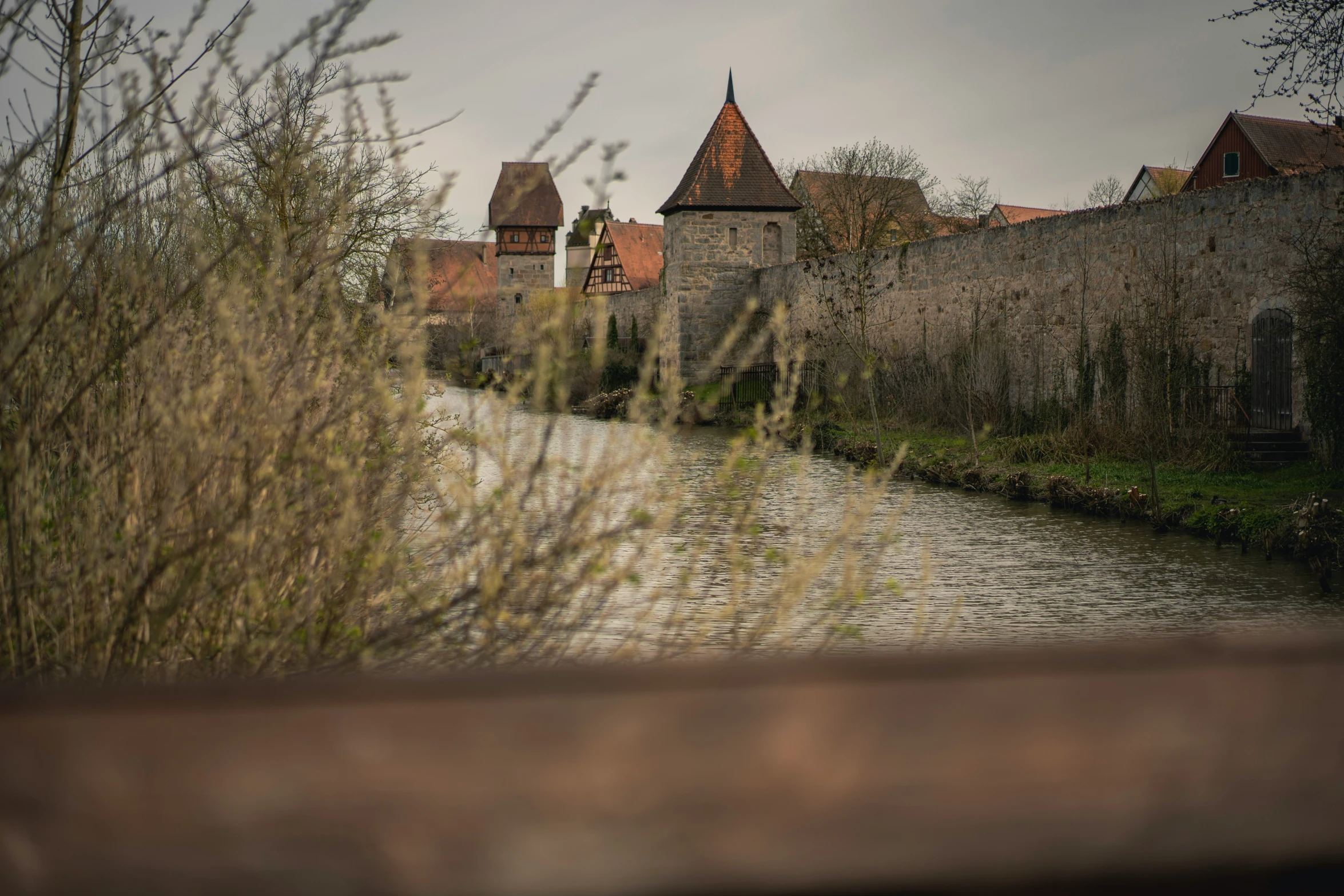 a small bridge crossing a stream in a town