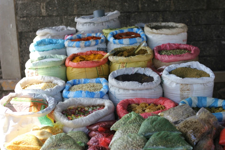 a pile of bags and bags of spices and other foods