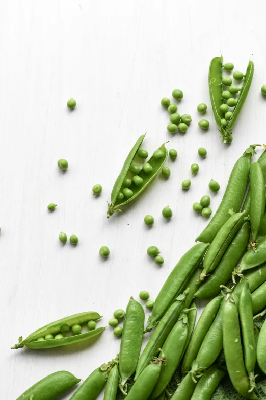 peas and peas on a table with peas still in it