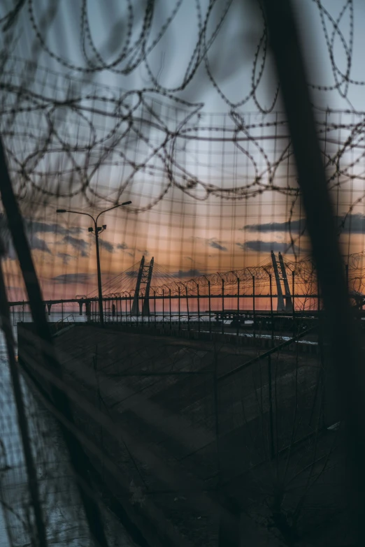 a picture taken from behind a fence at dusk