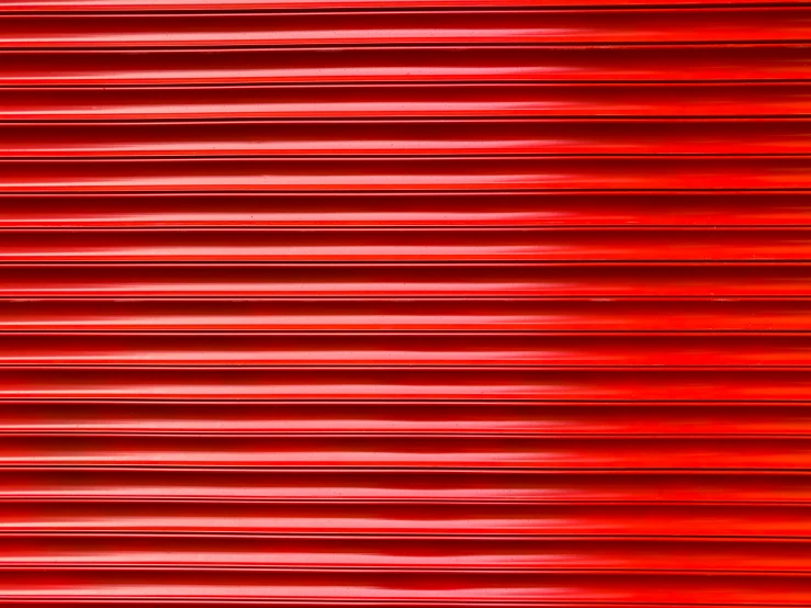the surface of a red roller shade