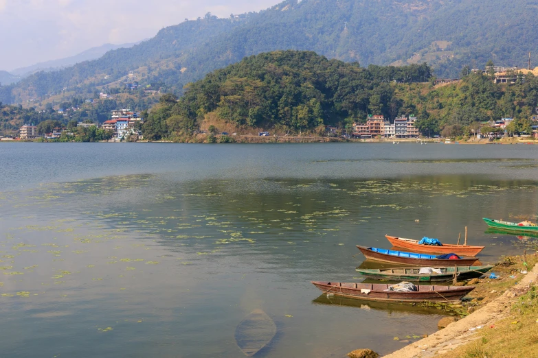 three boats that are floating on the water