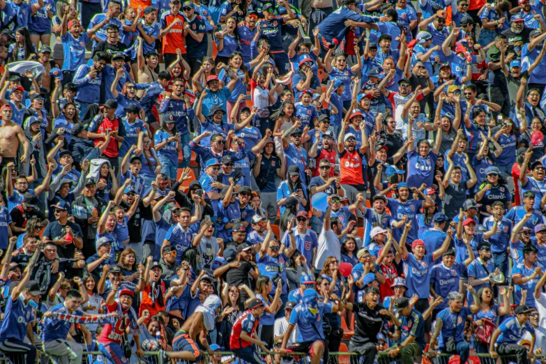 a large group of people standing in front of a blue wall