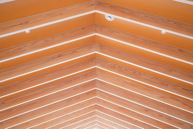 a very wide wooden ceiling with a lot of lights