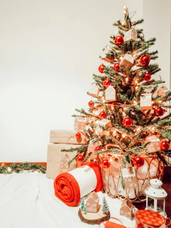 a christmas tree with red decorations and gifts
