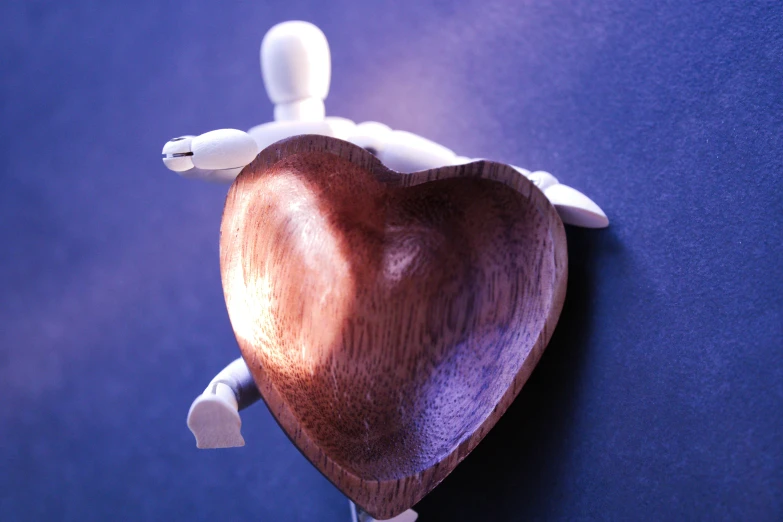 a wooden heart shaped object on a wall