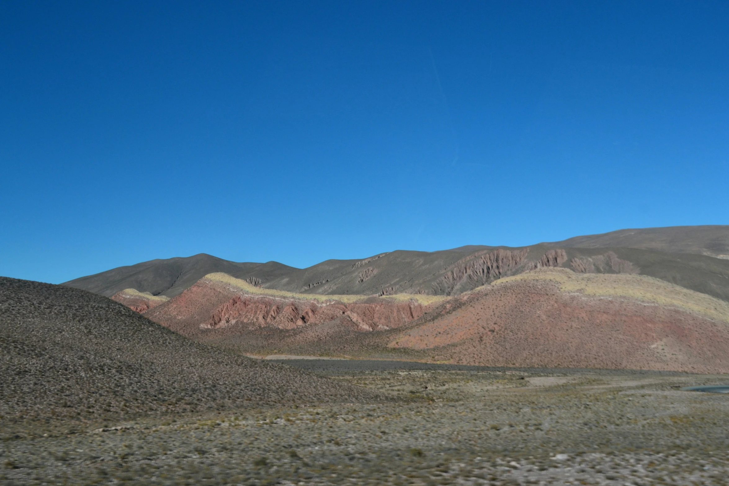 a mountain range with hills in the distance