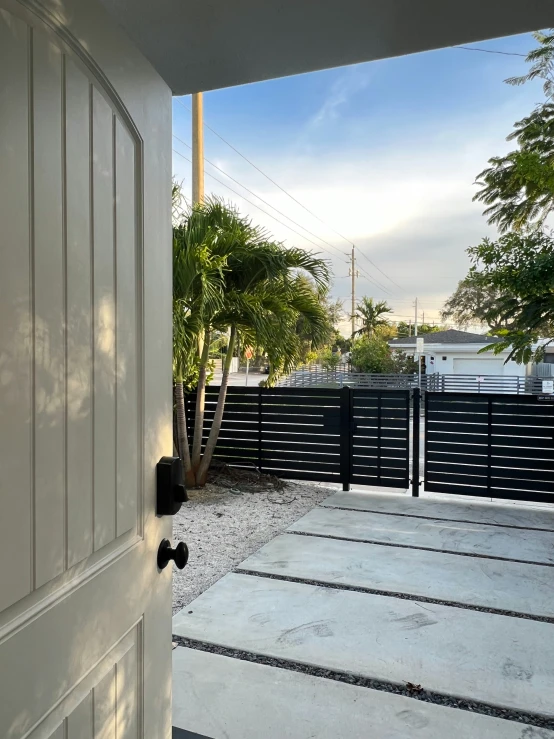 the open door of an outside patio with fence