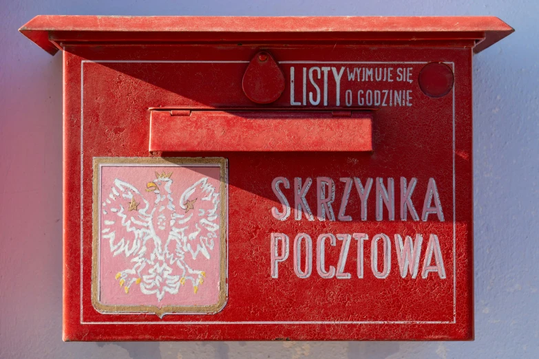 a mailbox with writing on it and a picture of a flag hanging off the back of it