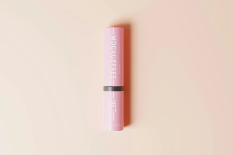 a mascara stick sitting on top of a pink surface