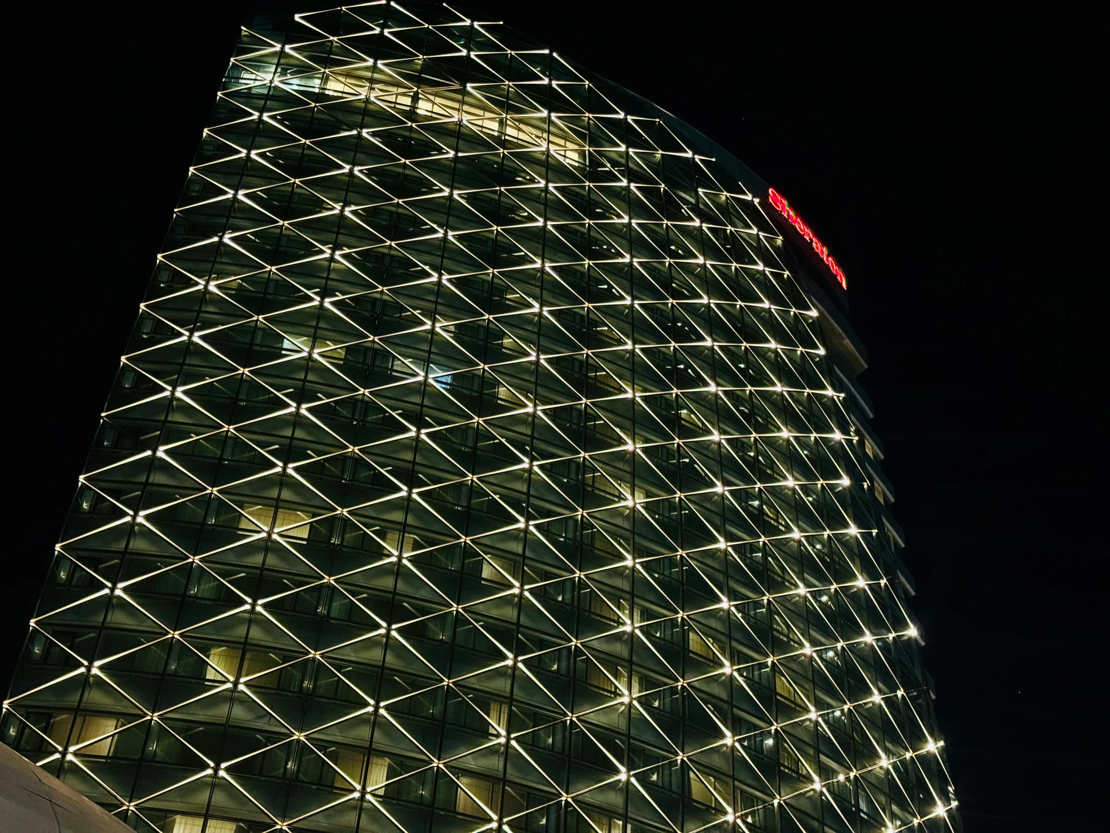 the very tall building is lit up at night