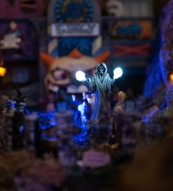 a table with an assortment of dolls and candles