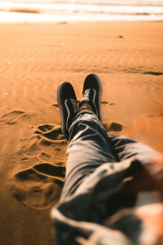 a person with their feet up on a beach