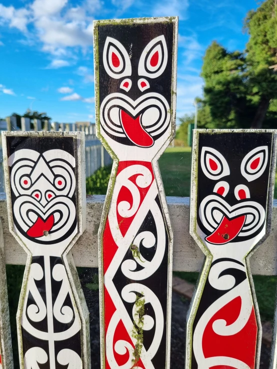 three decorative wooden sculptures on display on display