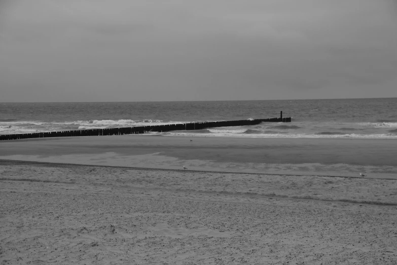 a view of the ocean with a man walking on it