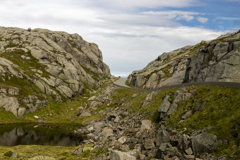 two rocks with a lake between them near one another