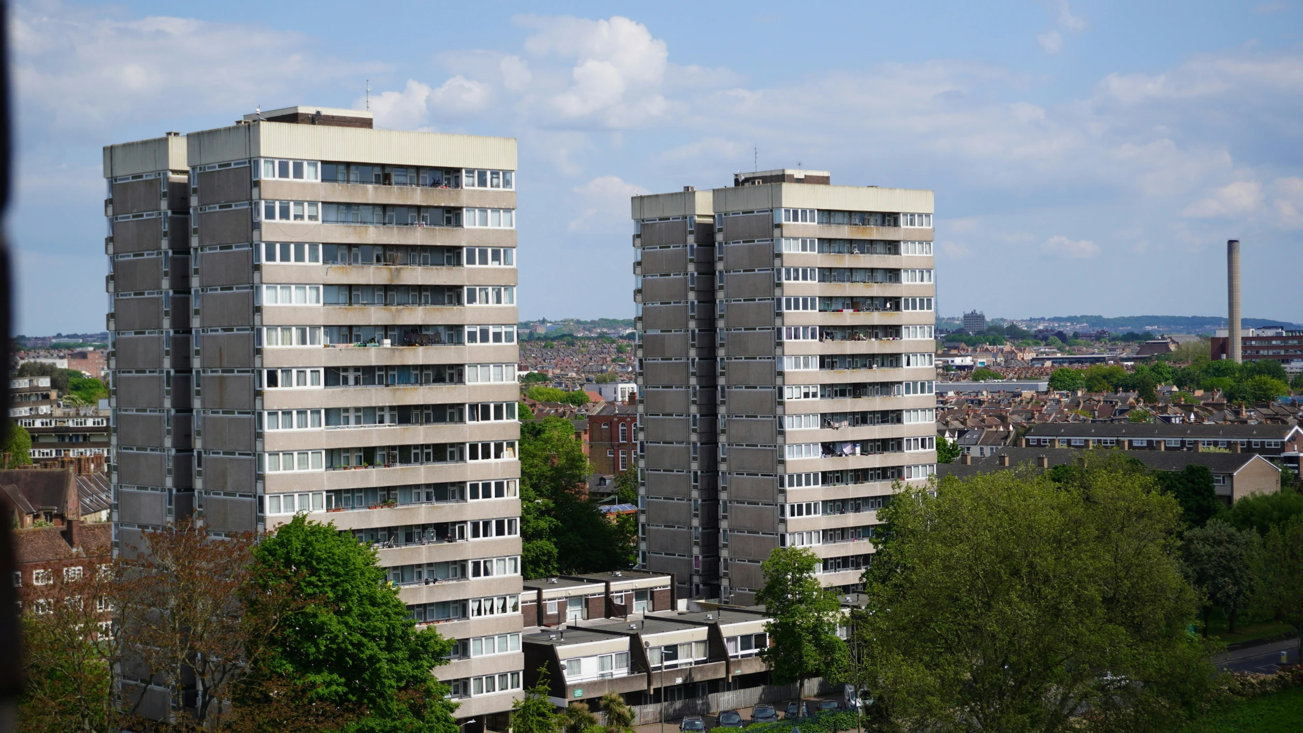 two building near trees in a large city