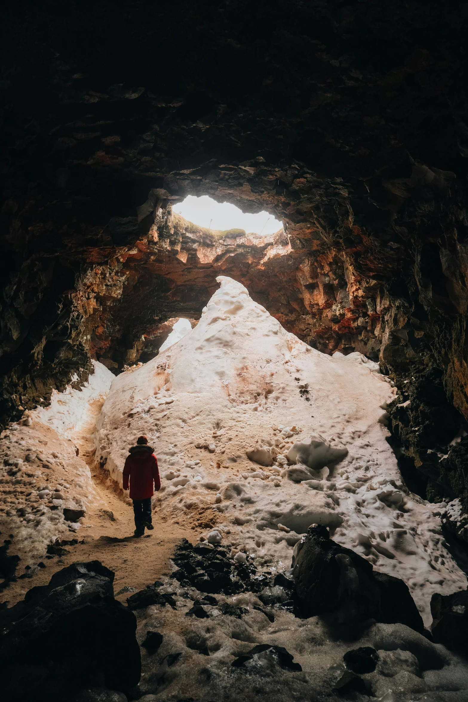 a person walks inside a cave in the snow