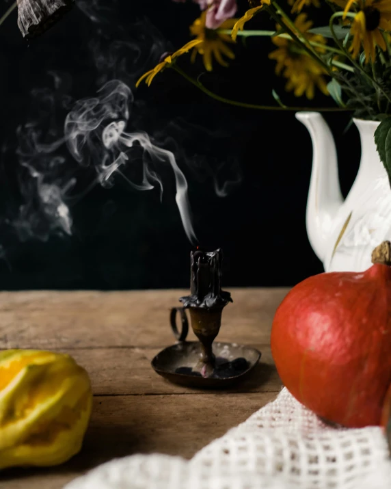 some flowers and fruit sitting on a table