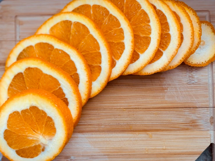 six peeled oranges on a  board