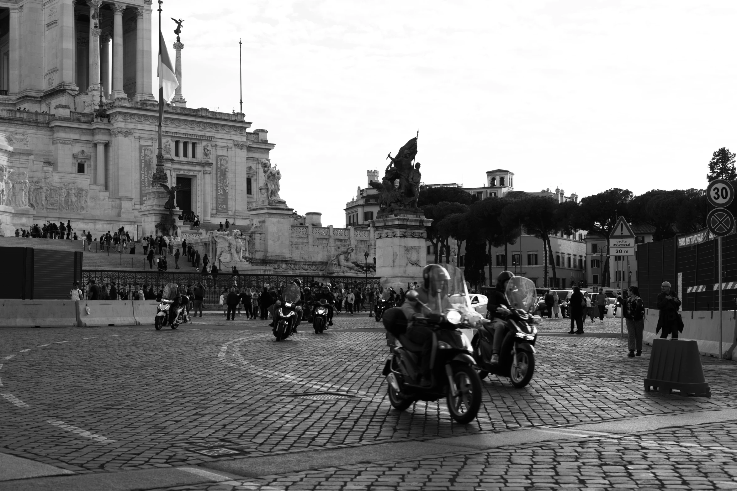 some people are on motorcycles and in black and white