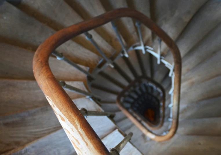 view from inside a wooden spiral stair railing