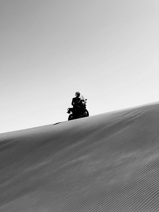 a motorcycle on the side of a very large hill