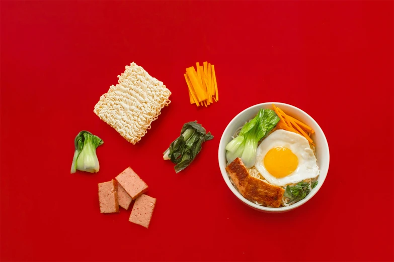 food is laid out in a bowl on a red background