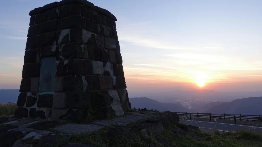 there is a tall tower sitting on the hill