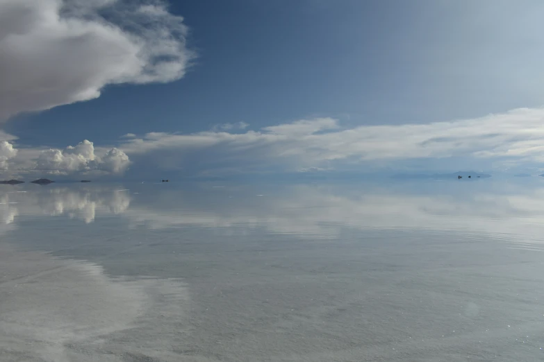 a beautiful sky with clouds and blue water