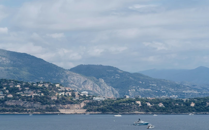 a boat on a body of water surrounded by hills