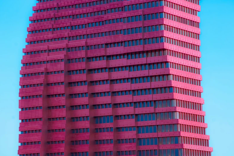 a tall red building that has windows around it