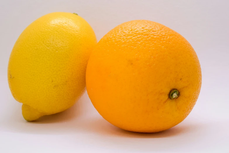 an orange and an lemon are shown on a white background