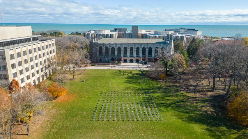 the buildings of a building overlook the water and trees