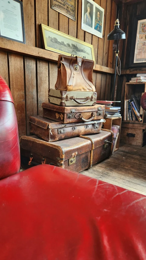 several suitcases, one sitting, all stacked next to each other in a room